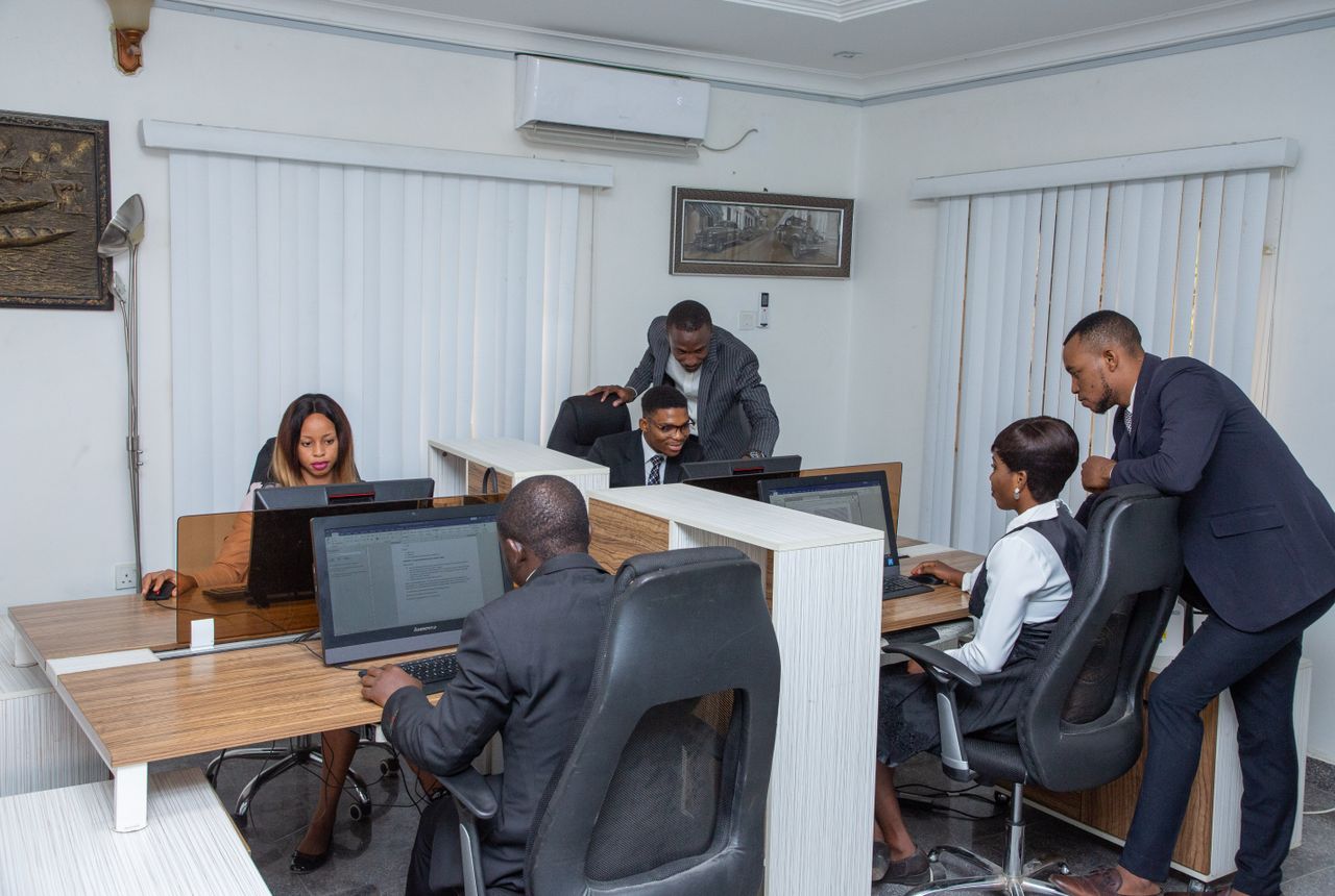 Home A group of professionals working together in a modern office setting, emphasizing teamwork and productivity.